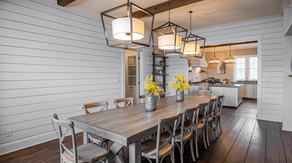 Rustic shiplap dining room with reclaimed farm table under three large geometric iron pendants