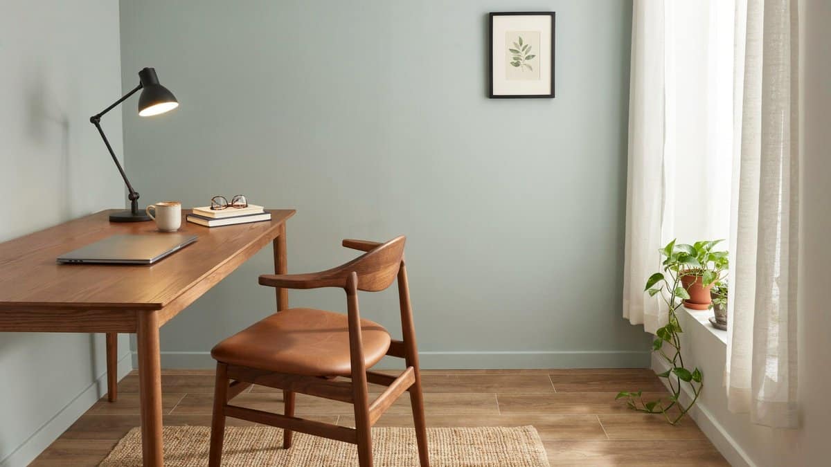 Wood plank vinyl surface under a walnut desk and task lamp
