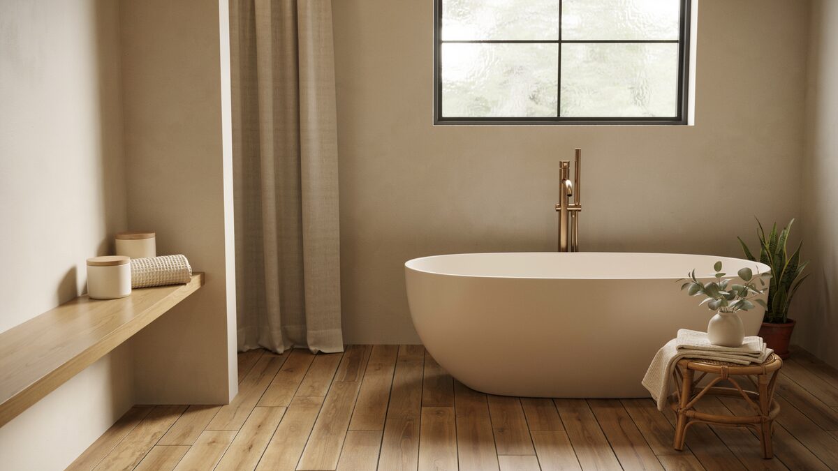 Beige soaking tub on bamboo planks under a black grid window
