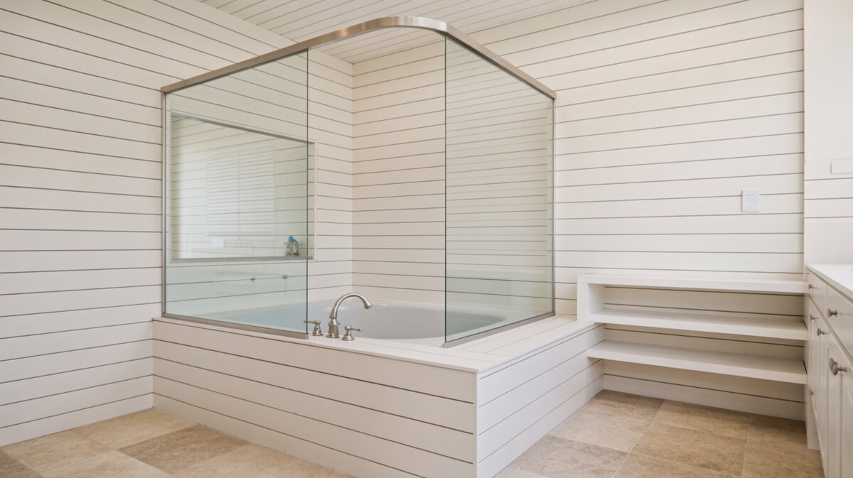 All-white bathroom with shiplap walls and ceiling, soaker tub, and sliding glass shelves