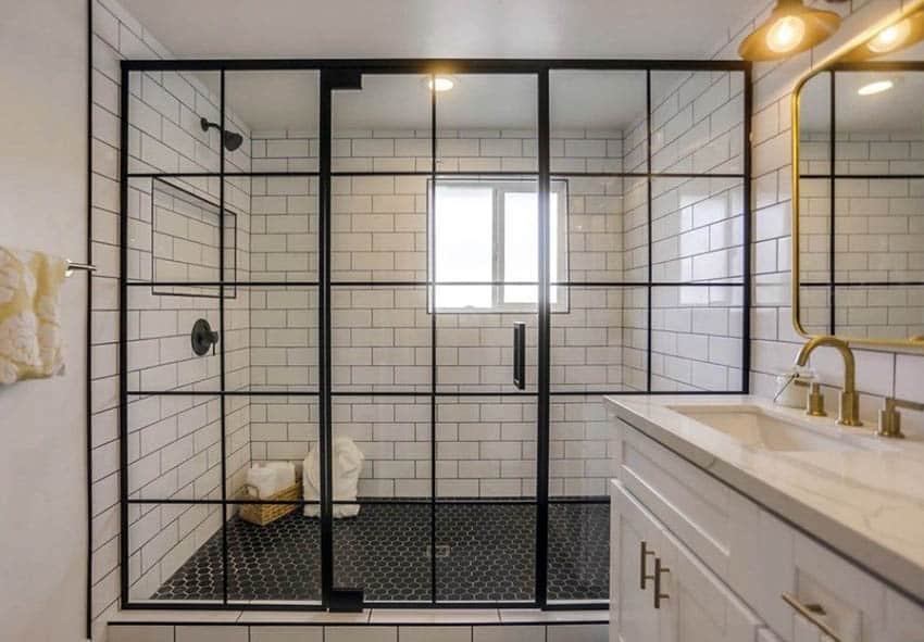 Bathroom shower with black octagonal floor tile and marble counters