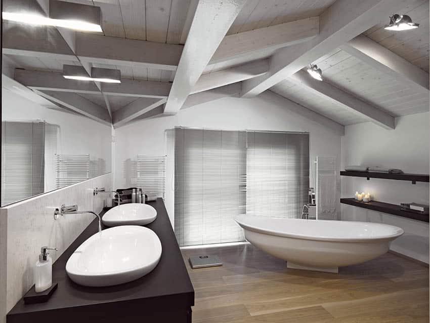 Gray washed ceiling boards and large freestanding tub