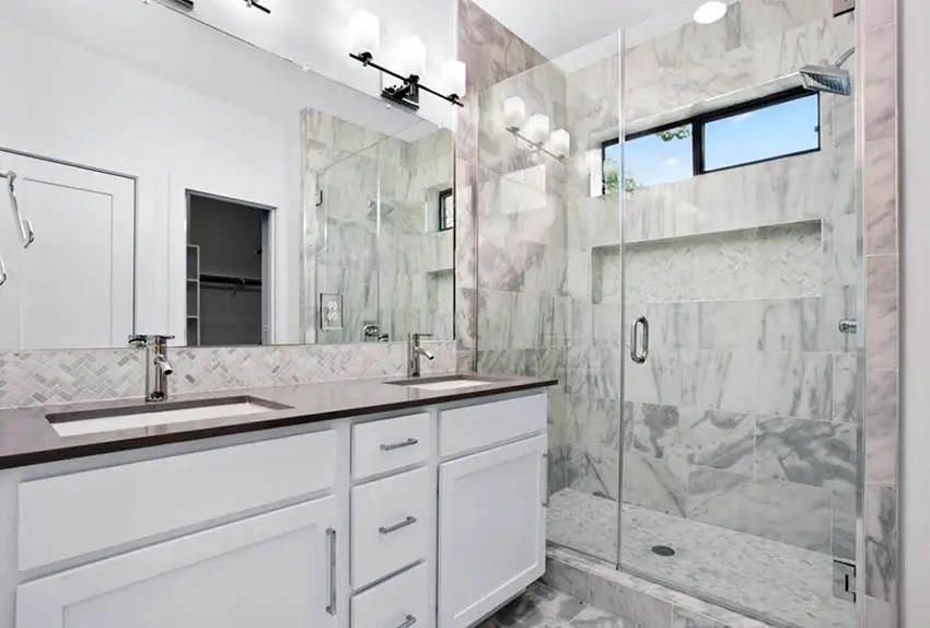 Bathroom with marble shower flooring 