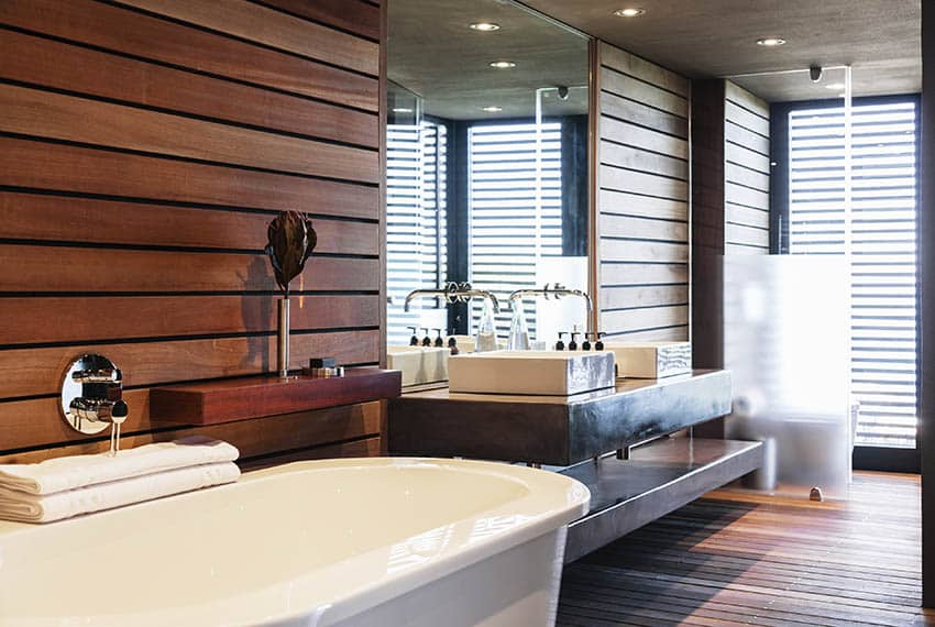 Bathroom with stained wood walls above tub and vanity