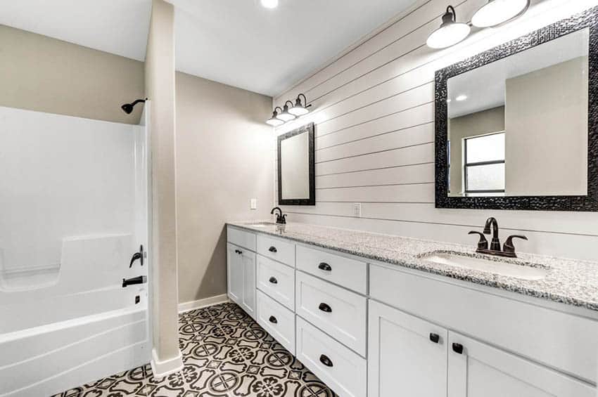 Bathroom with white wood above dual vanity and spanish tile floor