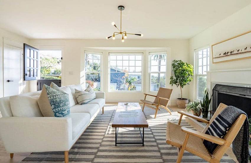 Beach style living room with white sofa wood flooring and picture windows