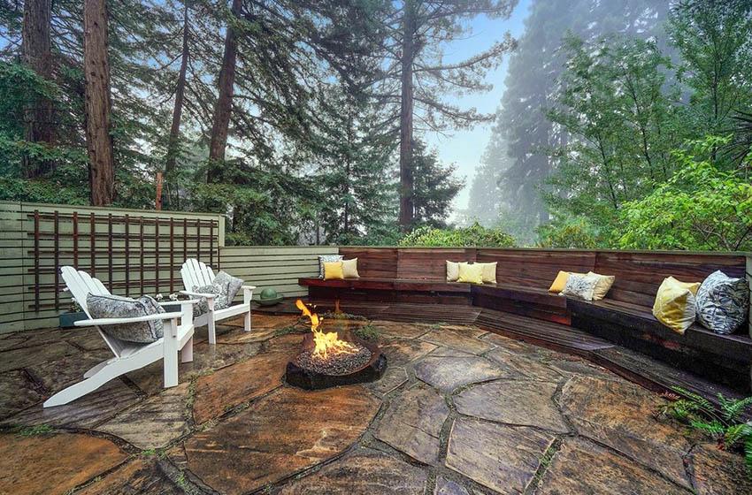 Flagstone patio with fire pit and wood bench