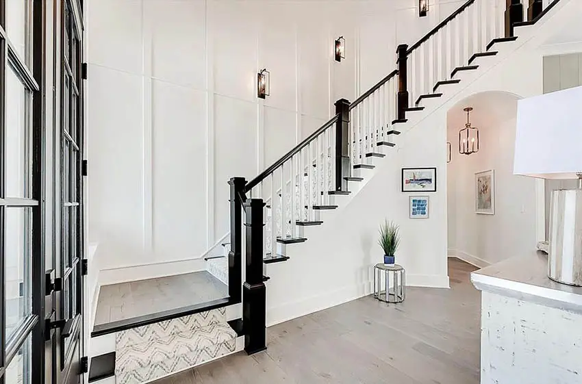 Foyer with white and black traditional style design railing