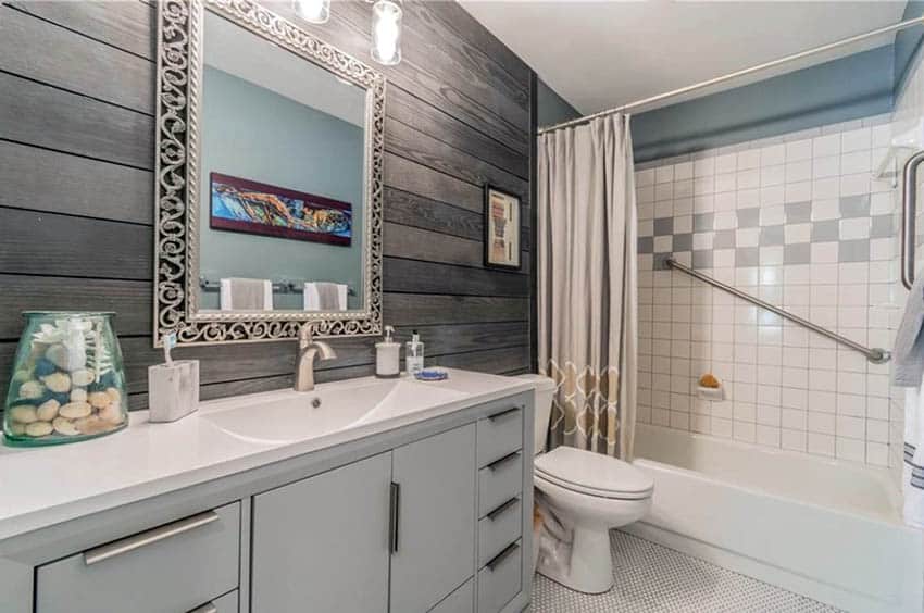 Guest bathroom with wood shiplap walls and square tile shower