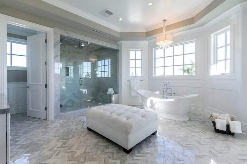 Master bathroom with full wall wainscoting cast iron bathtub and glass shower
