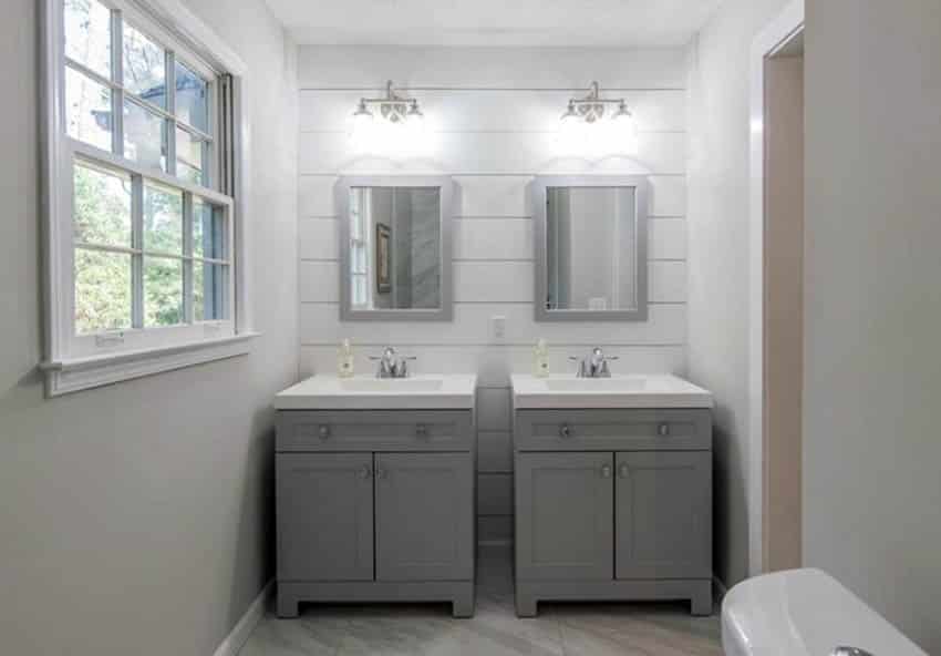 Master bathroom with shiplap accent wall and dual stand alone vanities