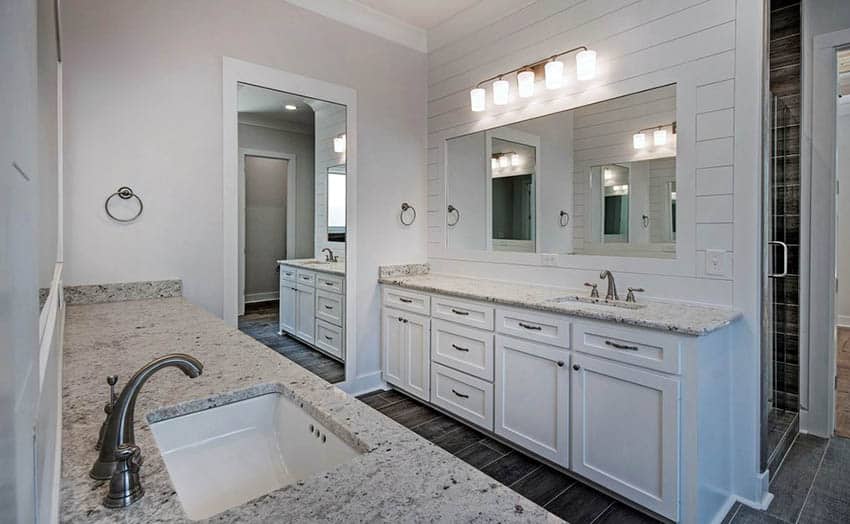 Master bathroom with shiplap walls and dual vanities