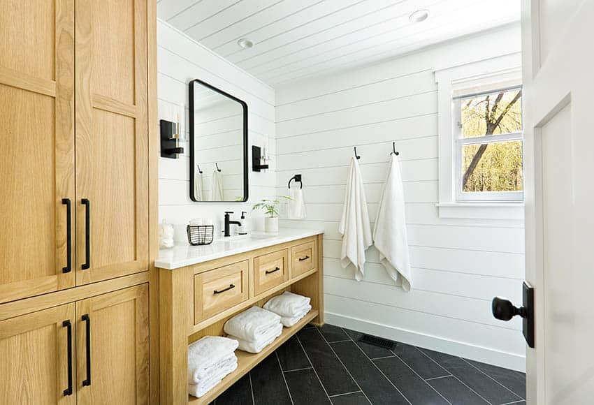 Modern farmhouse bathroom with white planks and black hardware finishes