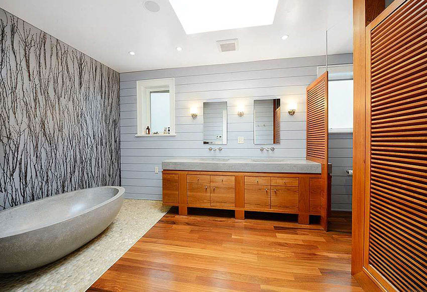 Modern master bathroom with shiplap wall, travertine bathtub and natural river rock floor