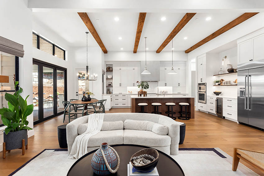 Open concept kitchen and living room design with wood beams floors