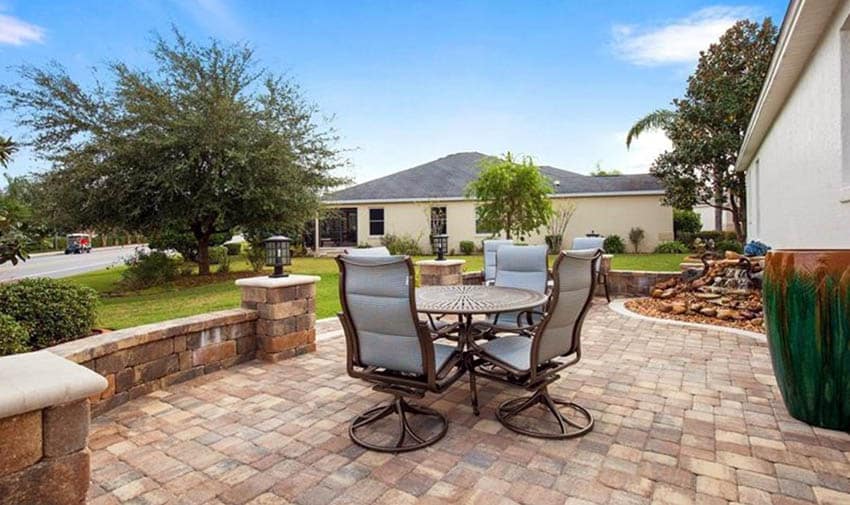 Paver patio with paver wall and outdoor lighting