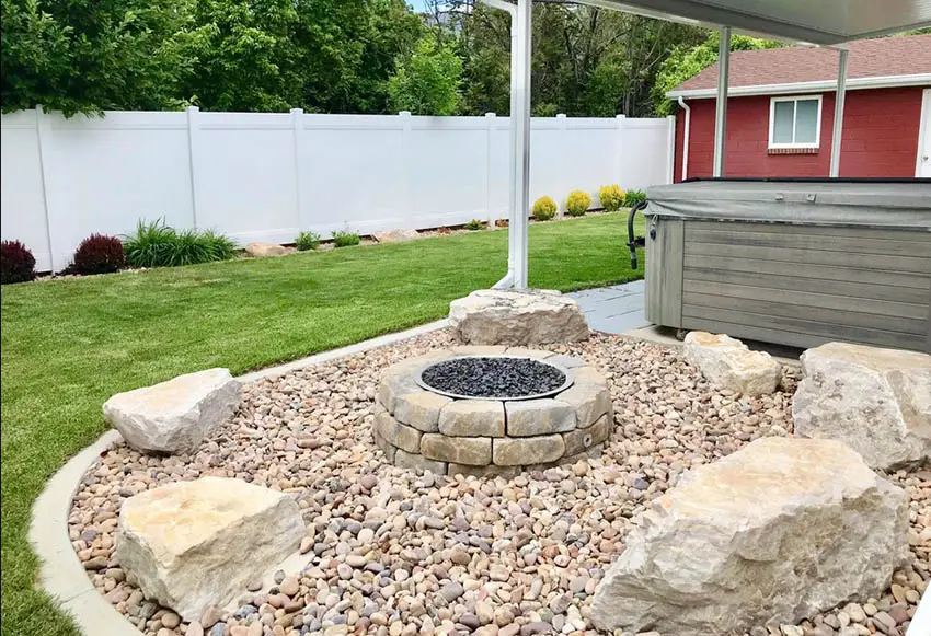 River rock patio with stone fire pit and bench rocks