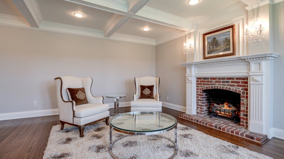 Traditional interior design living room with white coffered ceiling and brick fireplace