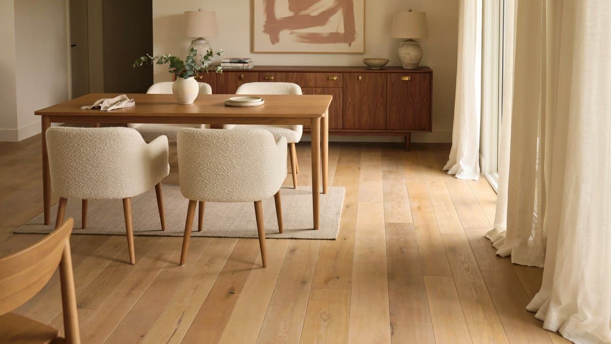 Transitional dining room featuring wide-plank European oak wood flooring and cushioned chairs