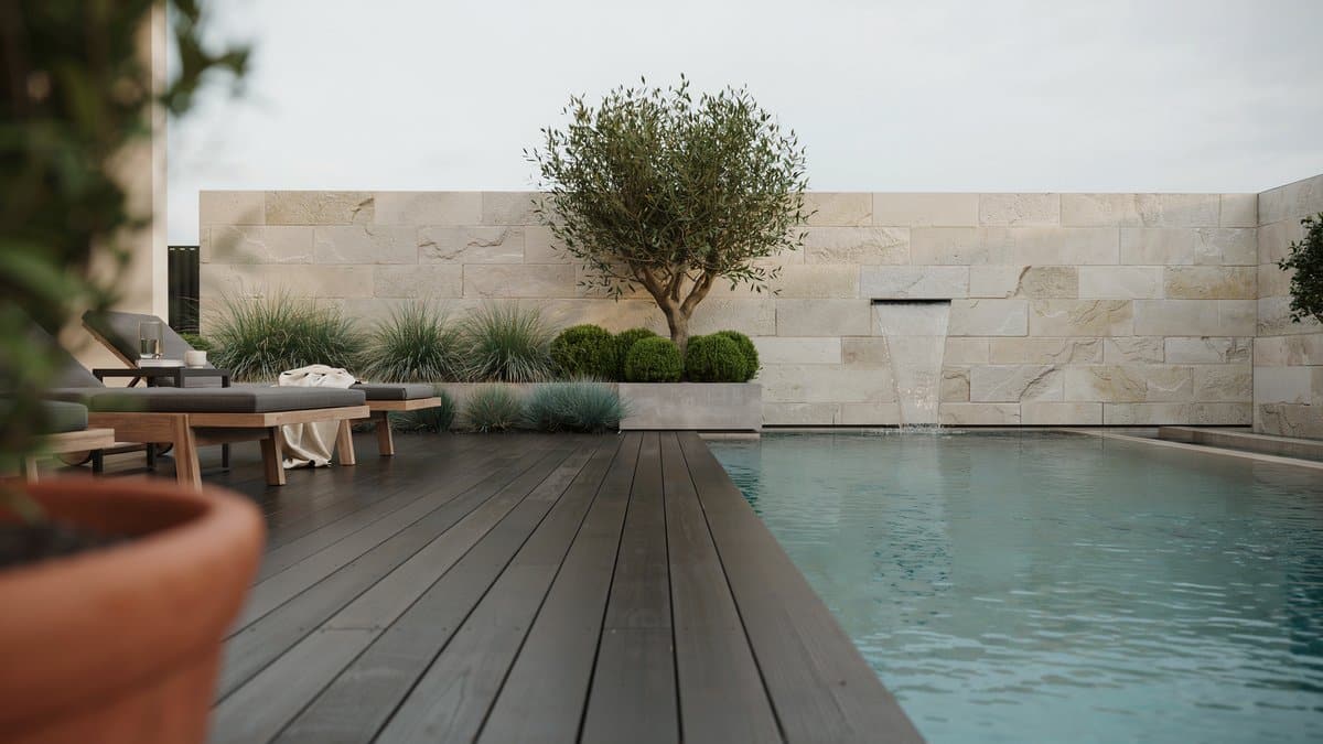 Quartz ledger stone panel wall with water feature beside a modern pool