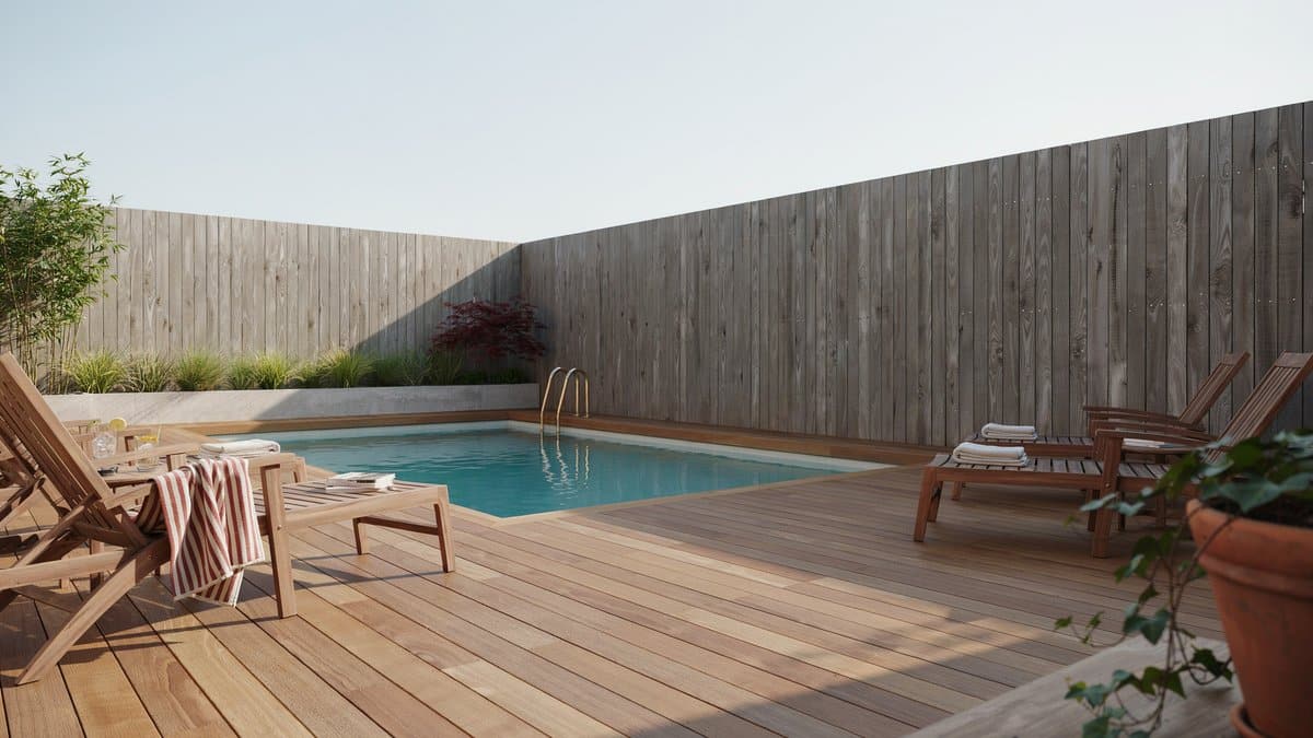 Solid wood privacy fence and timber deck wrapping a backyard pool