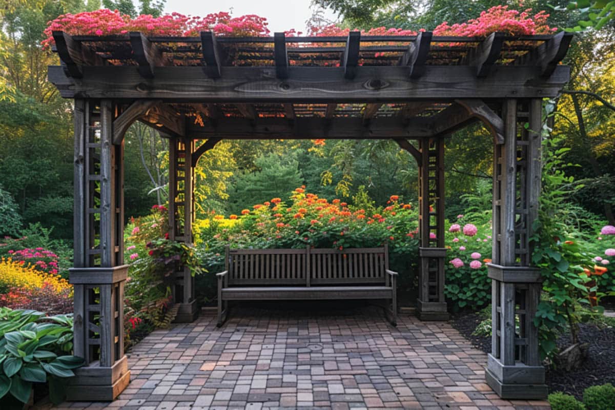 Pergola with sitting bench and garden flowers