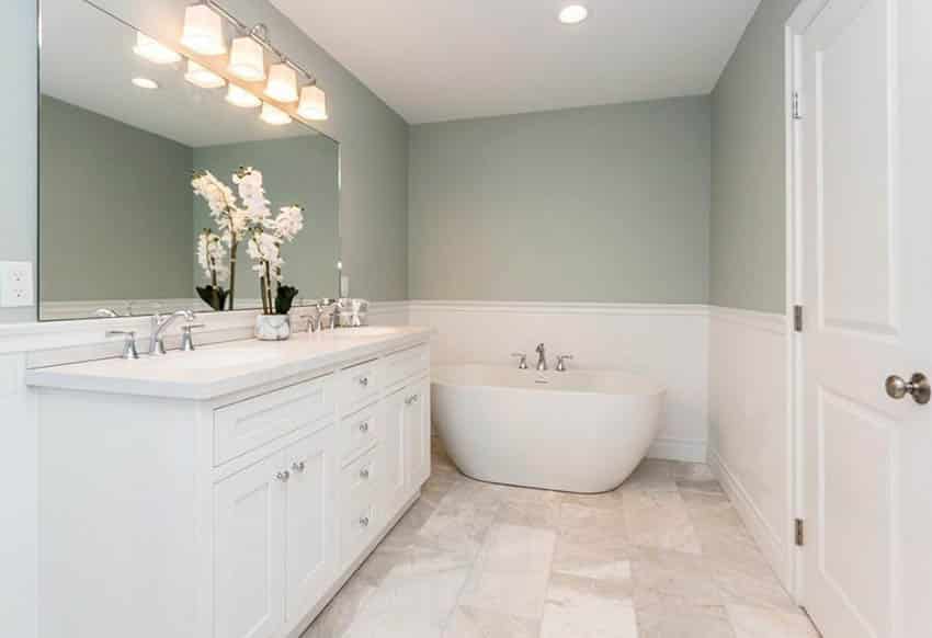 Bathroom with green walls, wainscoting and freestanding tub