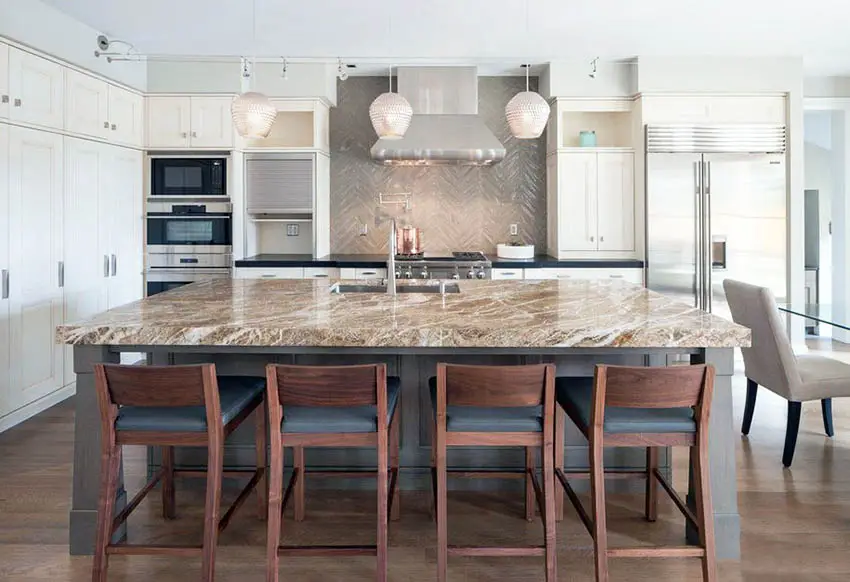 Contemporary kitchen with white main cabinets, brown quartz island, and black quartz countertops with porcelain tile backsplash