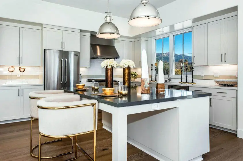 Contemporary kitchen with white shaker cabinets and dark quartz countertop island
