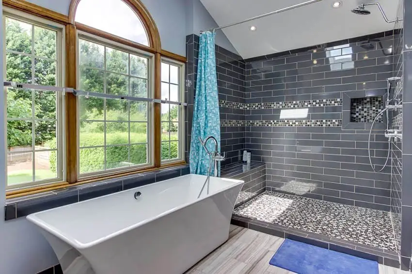Master bathroom with bench shower and freestanding tub