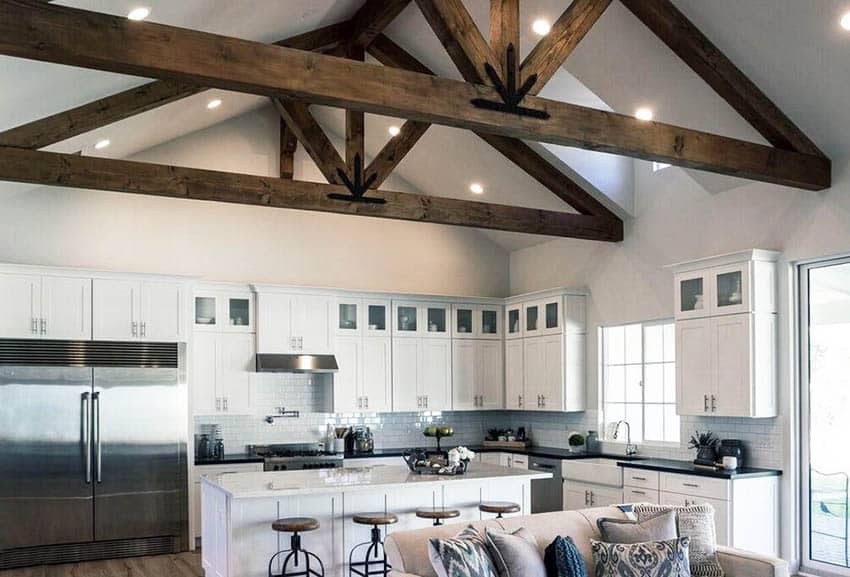 Kitchen with cathedral ceiling, white island and stools