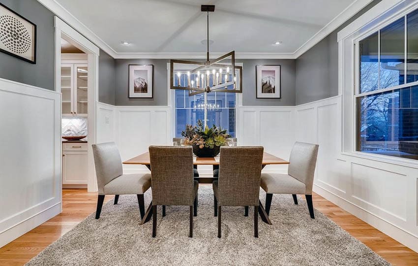 Dining space with tall wainscoting walls and gray paint