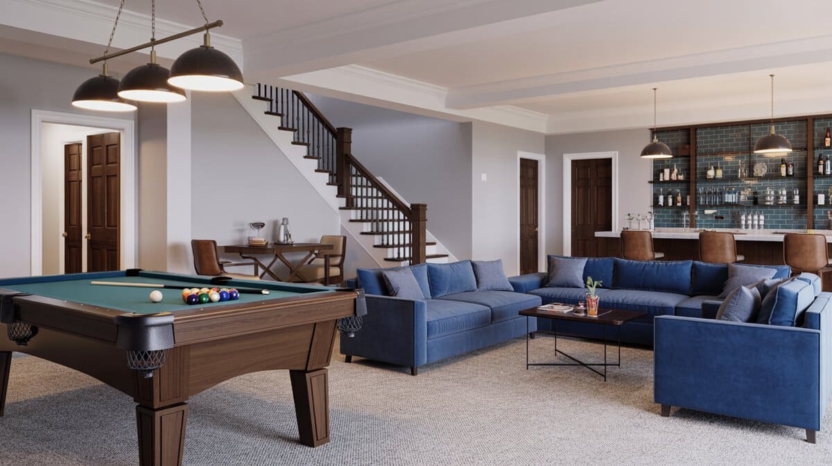 Finished basement recreation room with pool table in foreground and staircase with dark metal railing in background