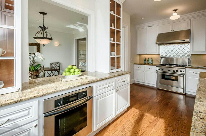 Kitchen peninsula with pass through window to dining room