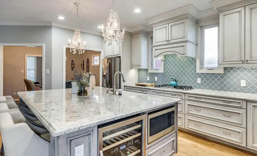 Kitchen with arabesque tile backsplash, distressed cabinets and granite island