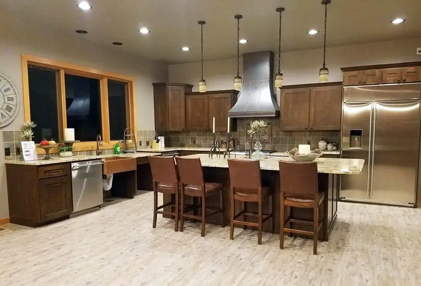 Kitchen with dark hickory cabinets and light laminate flooring