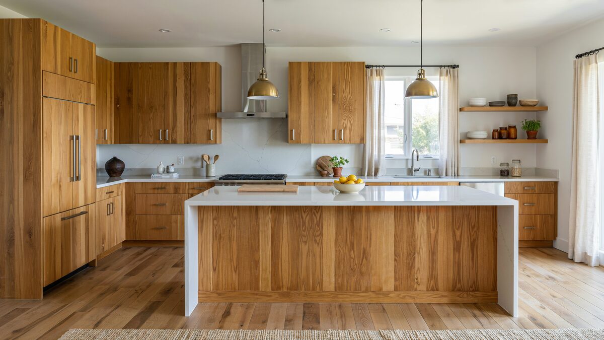 Cohesive hickory kitchen with matching wood floors cabinets and island tones