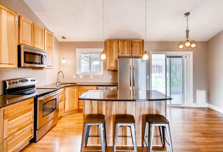 Kitchen with hickory cabinets and laminate flooring