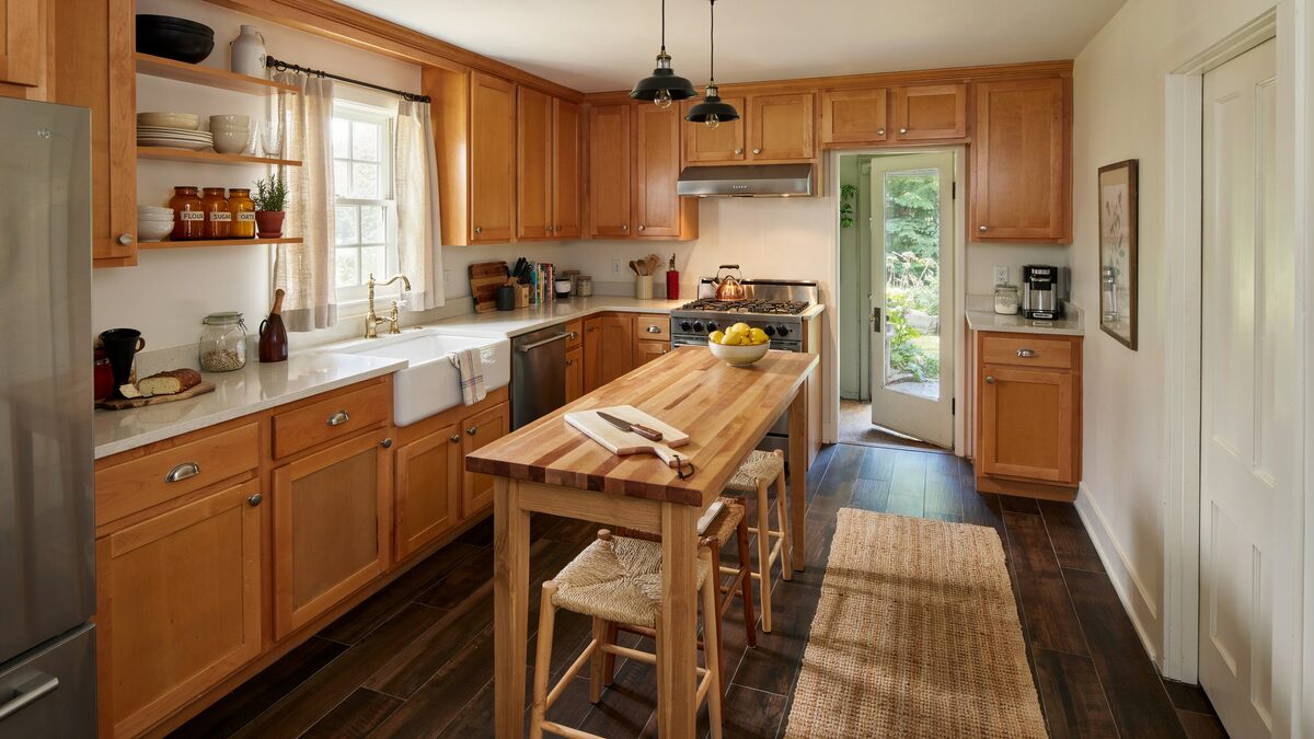 Country kitchen with hickory cabinets and dark wood look vinyl plank floors