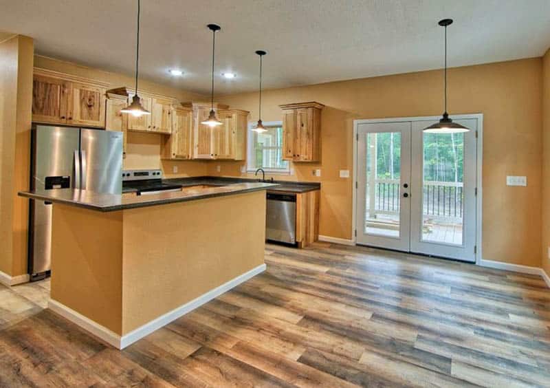 Kitchen with hickory cabinets and vinyl flooring