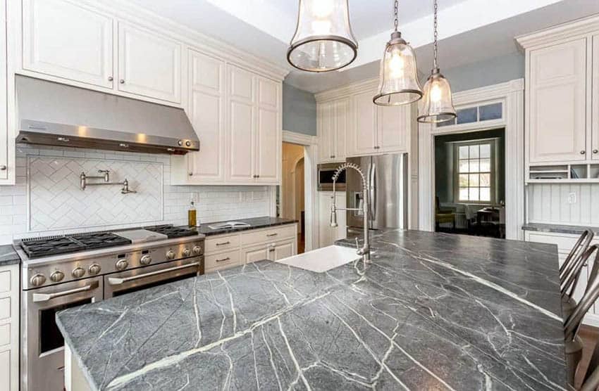 Kitchen with white cabinets and darker gray soapstone luxury countertops