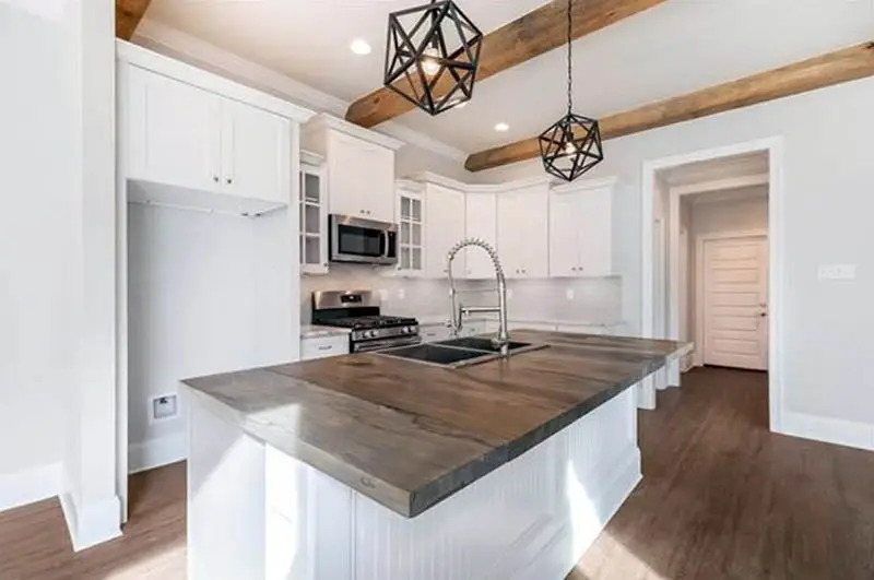 Kitchen with beadboard island and wood countertops