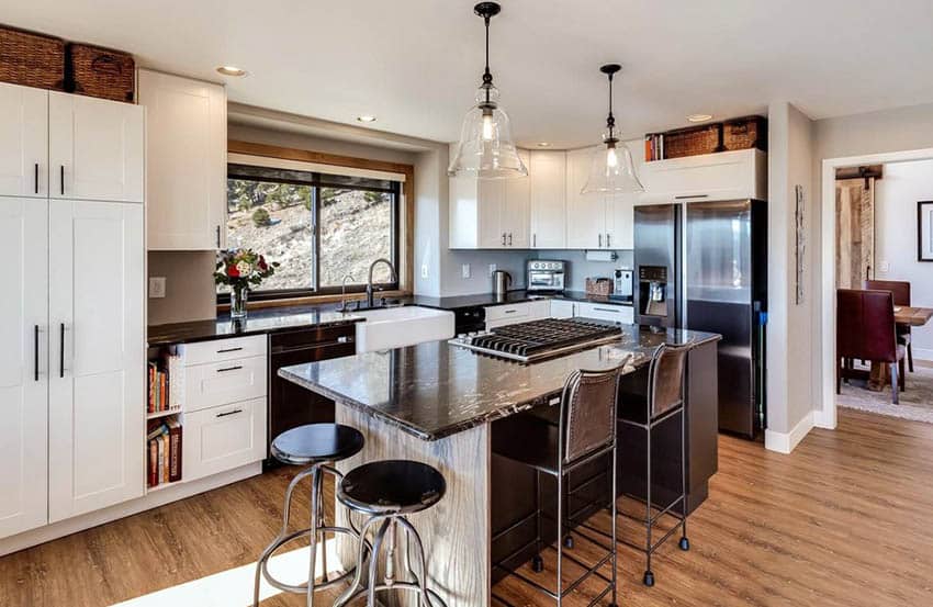 Kitchen with granite spotted island and wood base island and vinyl flooring