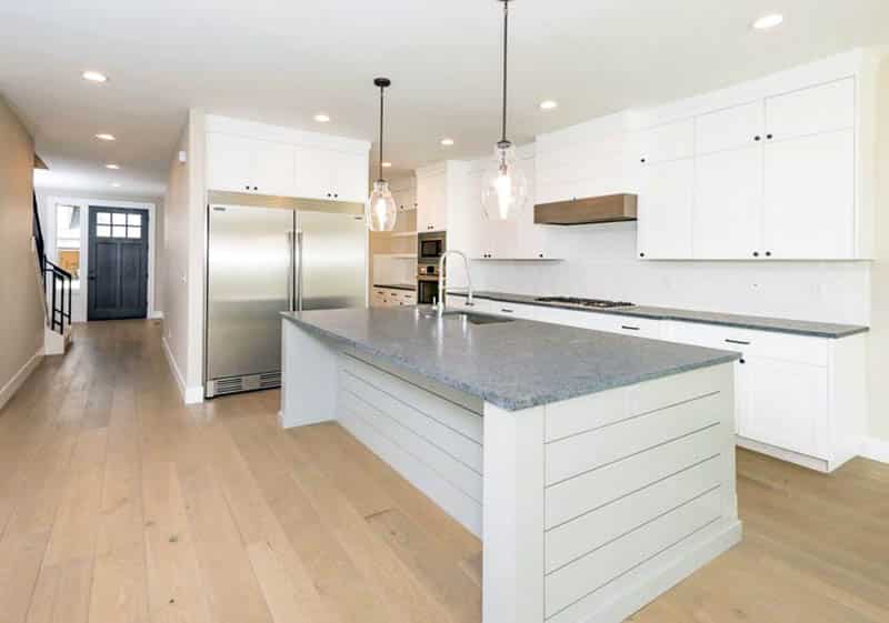 Kitchen with gray granite countertops and shiplap island