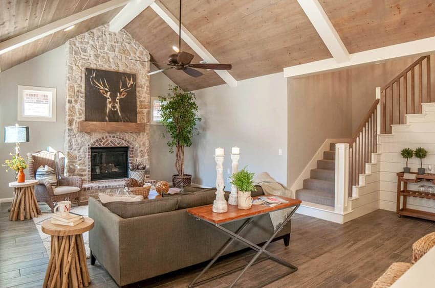 Room with wood tongue and groove ceiling, stone accent wall and staircase