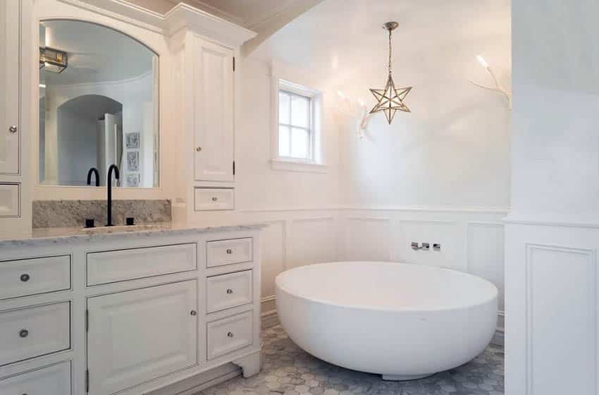 Master bath with white wainscoting and large tub