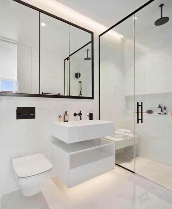 Black and white bathroom with mirror shower and bench