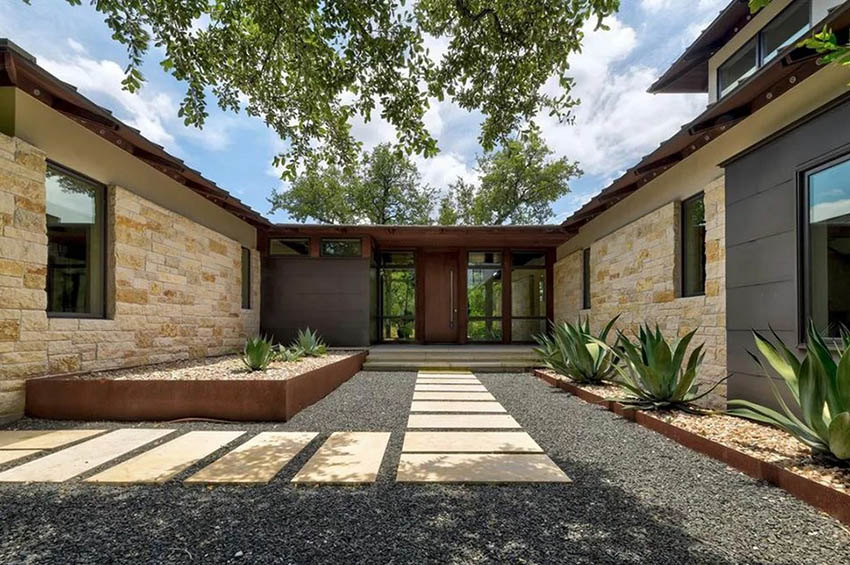 Modern home with gravel and large pavers