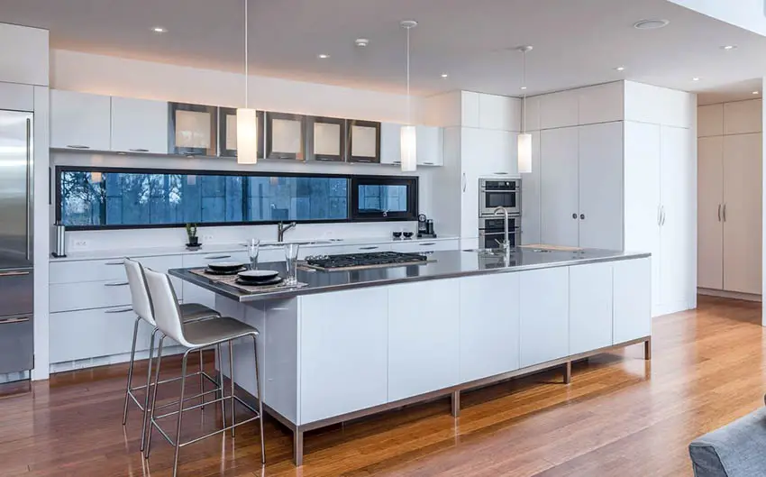 Modern kitchen with white storage cabinets and stainless steel countertop island