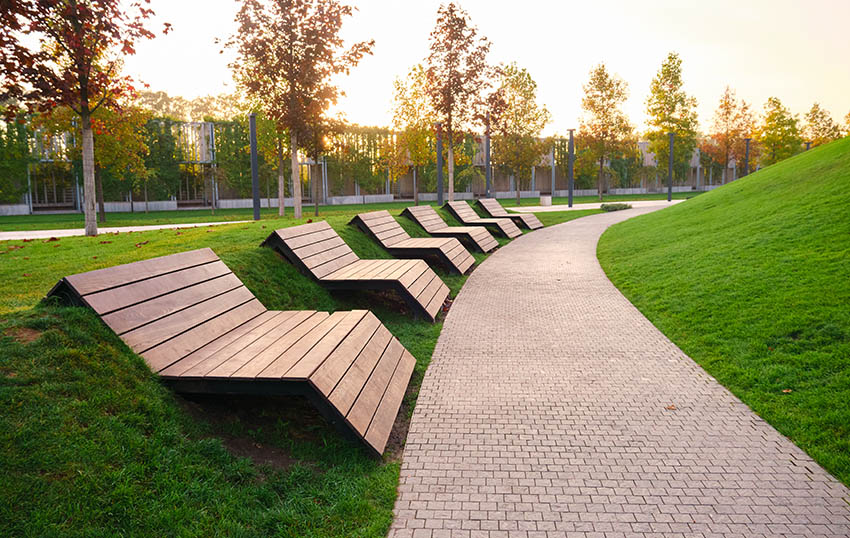 Modern outdoor wood slat benches on walkway